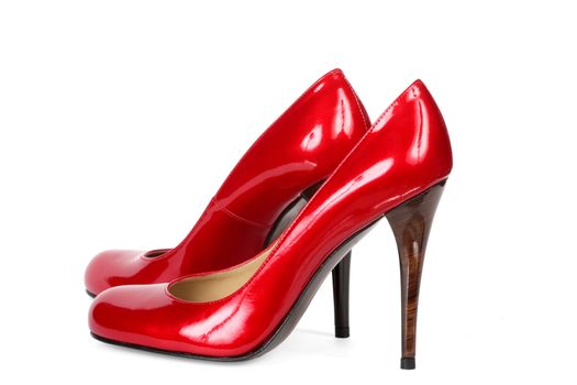 Red female shoes on a high heel. It is isolated on a white background