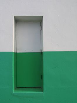door on a white and green building