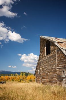 Rustic Barn Scene with Deep Blue Sky and Clouds