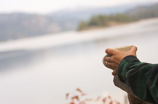 Woman Enjoys Morning Cup Coffee on the Lake.