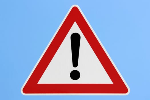 This image shows a attention road sign with blue background