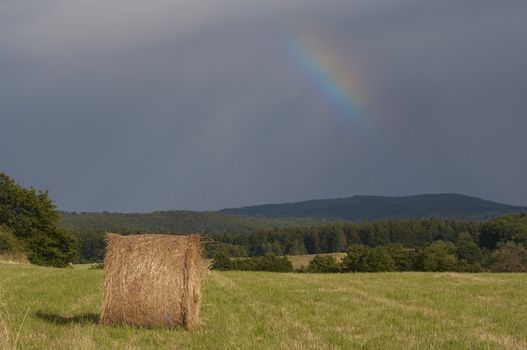 Shot of the dark sky with rainbow