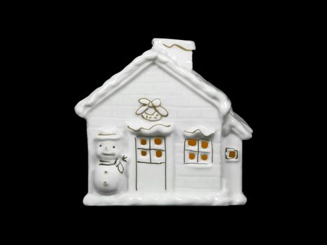 This image shows a 	porcelain house for Christmas with candle light