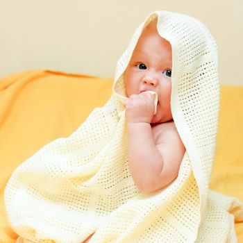 Seven month baby girl playing with blanket