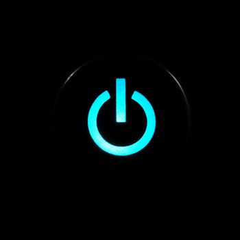 Blue glowing power button on black background