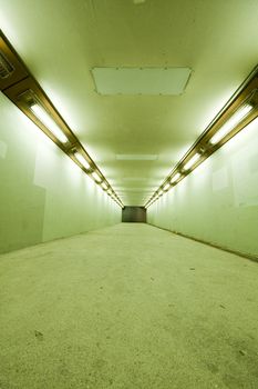 long tunnel with lamps and nobody walking