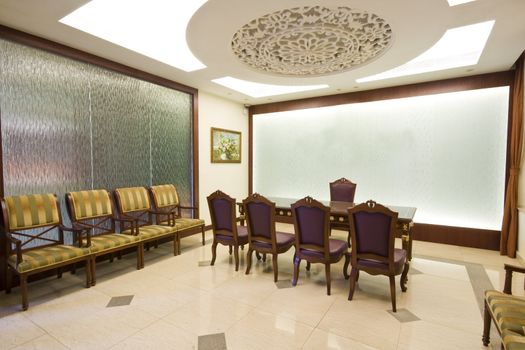 A large mahogany conference room table with leather chars
