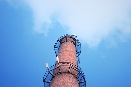 urban chimney-stalk on a background cloudy sky