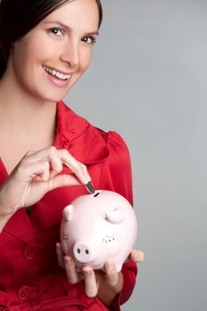 Woman saving money in piggy bank