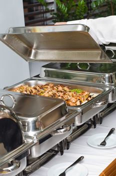 chafing dish heater filled with ready grilled fish kebab