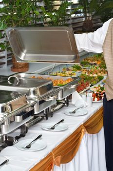 chafing dish heater filled with ready food inside