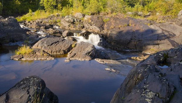 Calm above falls into the raging St. Louis river in Northern Minnesota