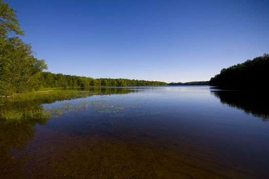 One of the 10,000 lakes of Minnesota in blue sky and water