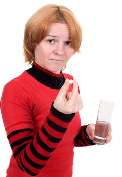 The sick girl with tablets and a glass