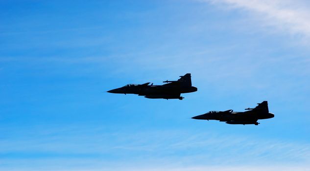 Two aircraft Jas 39 Gripen on blue sky
