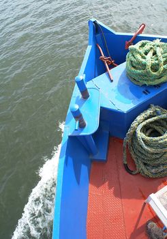 Front of a ship crossing a lake.                