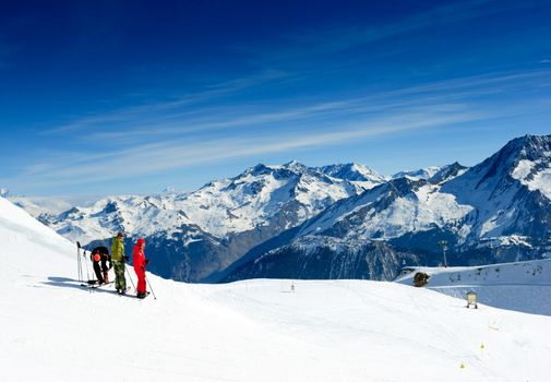 Skiers on the top of the mountain in Meribel Valley at French Alps