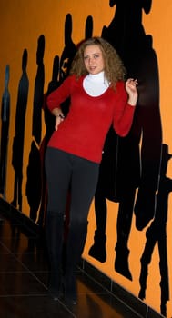 happy young girl against orange wall