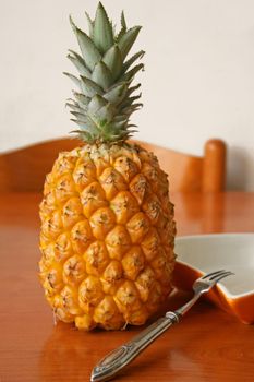 Fresh pineapple on the wooden table.
