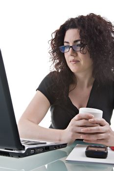 Beautiful brunette, using her laptop. Studio shot, isolated on white background.