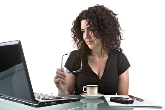 Beautiful brunette, using her laptop. Studio shot, isolated on white background.