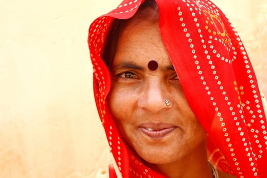 Old woman wearing a beautifully embroidered sari