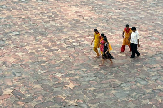 Asian family walk on stony street