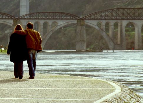 Couple walking along the river margin