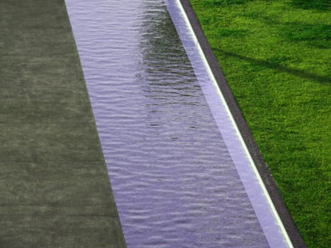 Decorative water channel between stone and grass