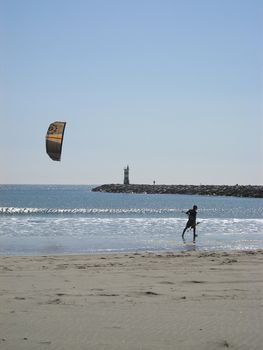 Kitesurfer alone on a beach     
