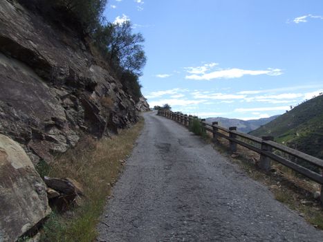 Mountain road with high ascent leading to the sky