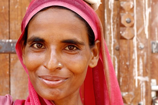 Old woman wearing a beautifully embroidered sari