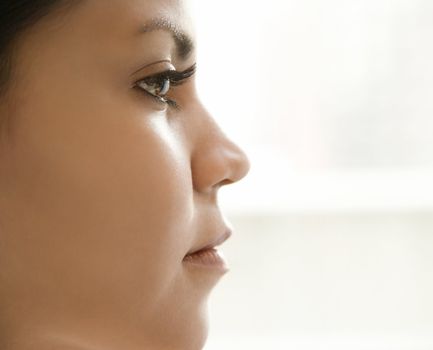 Close up profile of Hispanic young adult womans face.