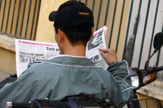 Asia man reading newspaper -Vietnam