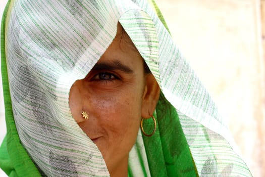 Old woman wearing green sari