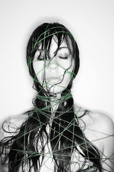 Nude Caucasian young adult woman wrapped in string.