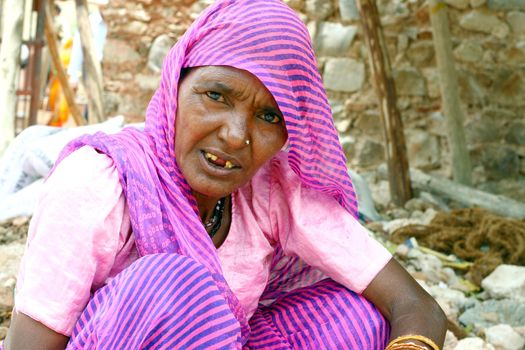 Old woman wearing pink sari