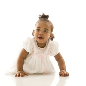 Portrait of African American infant girl against white background.