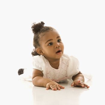 Portrait of African American infant girl against white background.