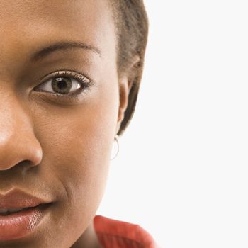 Close up portrait of African American woman against white background.