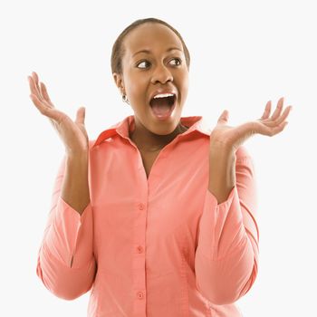 Portrait of African American woman looking surprised against white background.