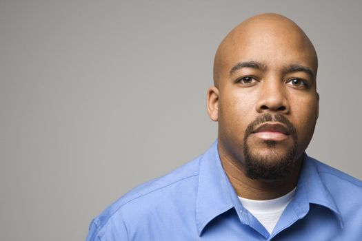 Portrait of African American man against gray background.