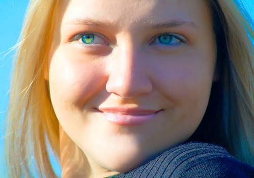 Portrait of the beautiful blondy against blue sky