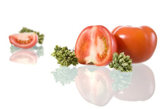 Tomatoes and oregano leafs, isolated on white background.