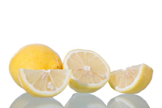 Sliced lemon, isolated on white background with reflection. Studio shot.