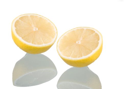 Sliced lemon, isolated on white background with reflection. Studio shot.