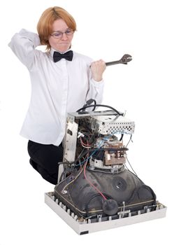 The girl repairing the old electronic equipment