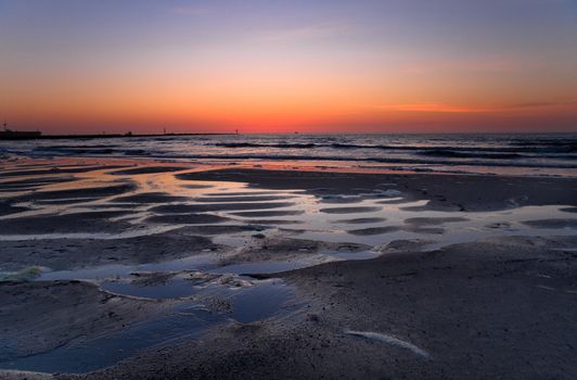 Coloured sky from volcanodust in the air after the sunset at the beach -  horizontal image