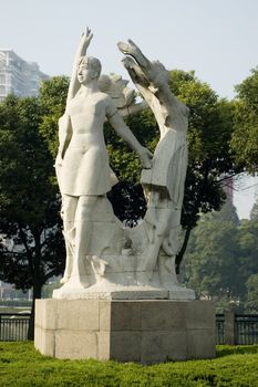 China, Jiangsu province, Nantong city center. Sculpture showing young Chinese females excersising.
