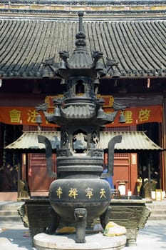 Traditional Chinese temple in Nantong city, Jiangsu province, China. Temple consists of few buildings, tower, monk's hostel and fireplace for incense. 